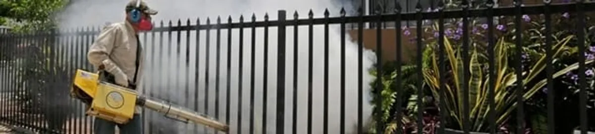 Mosquito control technician fogging a yard perimeter for mosquito reduction in Memphis, TN